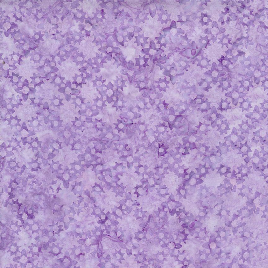 Flower Grove Lilac Tonga Batik fabric by Timeless Treasures featuring small tonal floral shapes in lilac, lavender, violet, and pale purple.