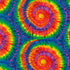 Cassidy Multi Tie-Dye fabric by Timeless Treasures featuring large rainbow spiral tie-dye circles in blue, green, yellow, orange, red, pink, and purple.