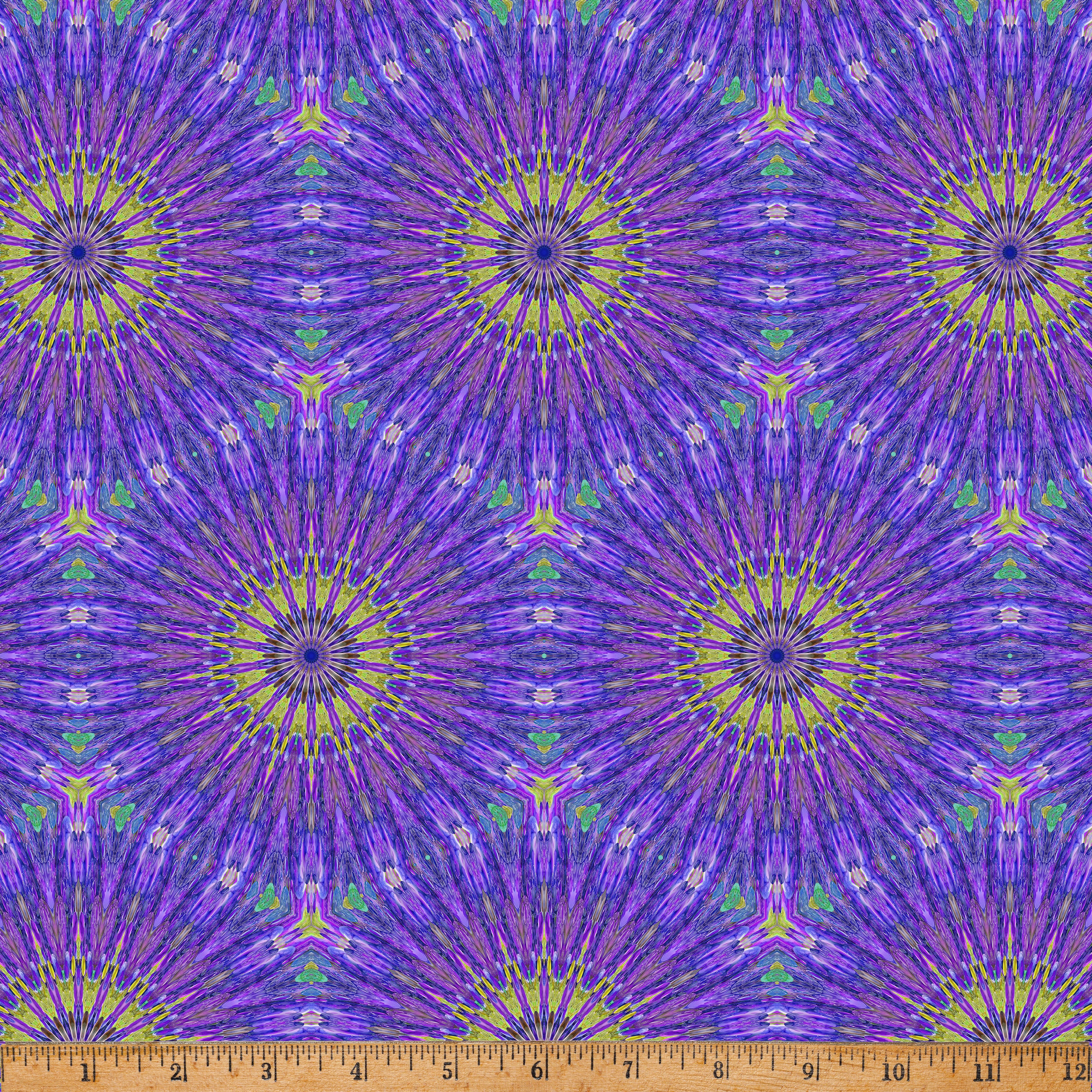 Radiant Kaleido Star Purple digital print fabric by Marlies Janssen of Candy Quilt Designs for Hoffman Fabrics featuring vibrant kaleidoscope starbursts in shades of purple, violet, lavender, lime green, teal, and blue on premium quilting cotton.