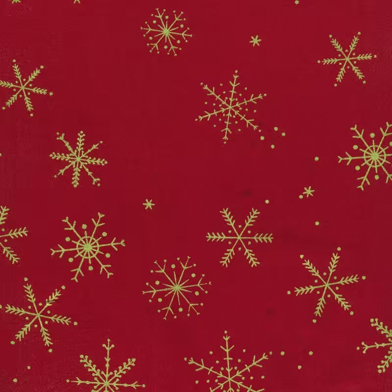 A vibrant red fabric from the Ombre Flurries Metallic collection by V and Co. for Moda Fabrics, featuring shimmering gold metallic snowflakes scattered across the surface.