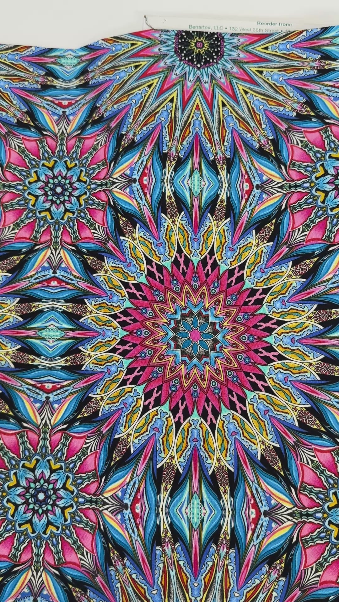 Where in the World Rio Blue Multi cotton fabric by Paula Nadelstern featuring colorful kaleidoscope medallions in blue pink yellow and black.