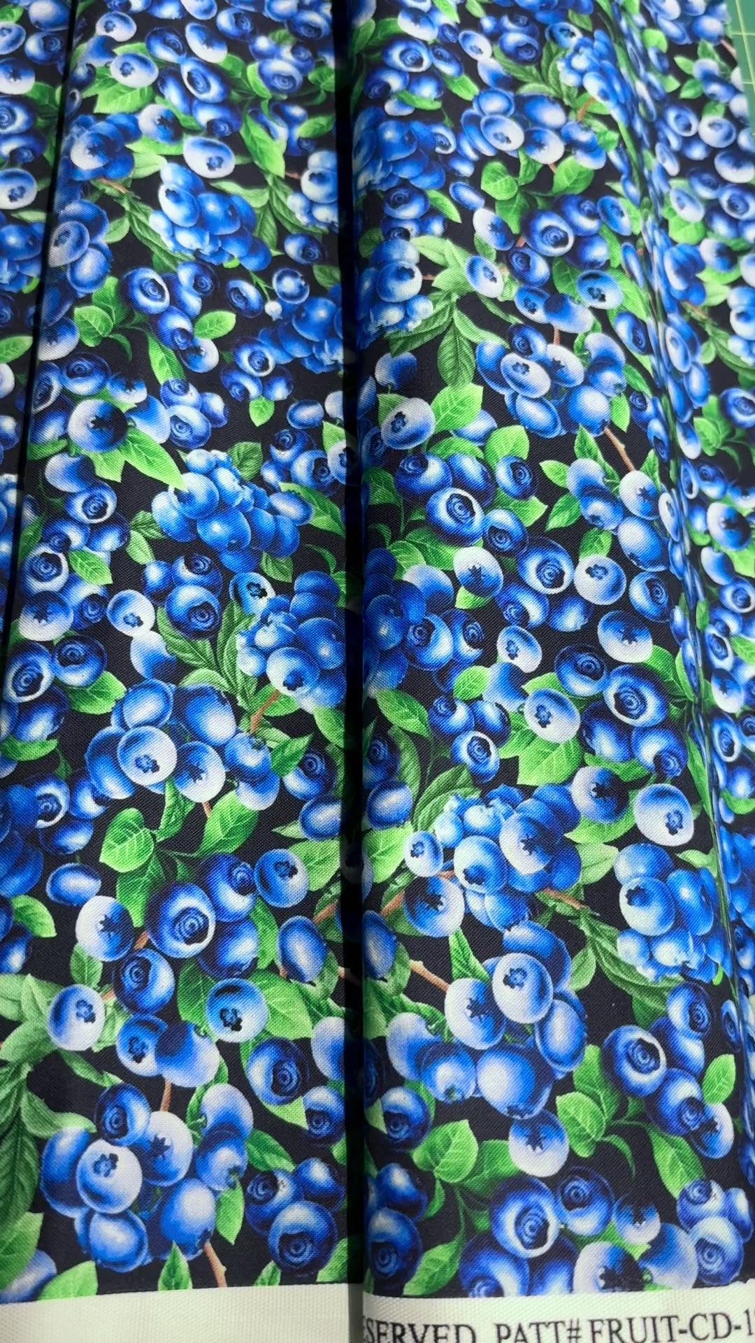 Blueberry Delight - Blueberries Bush Fabric by Timeless Treasures featuring realistic blueberries with green leaves on a navy background.