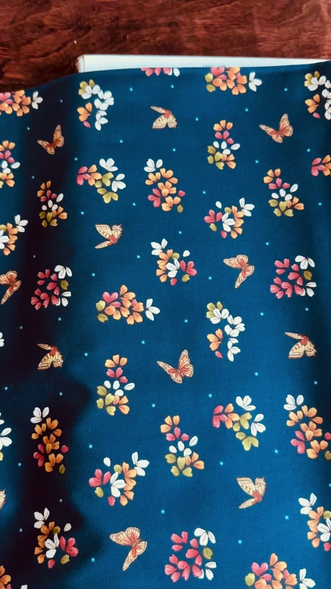 Navy cotton fabric featuring delicate floral blossoms and butterflies scattered throughout, from the Japanese Garden collection by Maywood Studio.