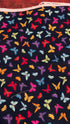 Colorful rainbow butterflies scattered on a black background fabric by Chong-A Hwang for Timeless Treasures.