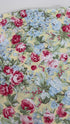 Floral cotton fabric featuring pink roses, blue hydrangeas, and delicate blossoms on a soft butter yellow background from the Simply Chic collection by Anna Stuart for Benartex.