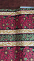 Holiday Flourish 12 poinsettia stripe black metallic fabric featuring red poinsettias, holly leaves, and gold scrollwork by Peggy Toole for Robert Kaufman.