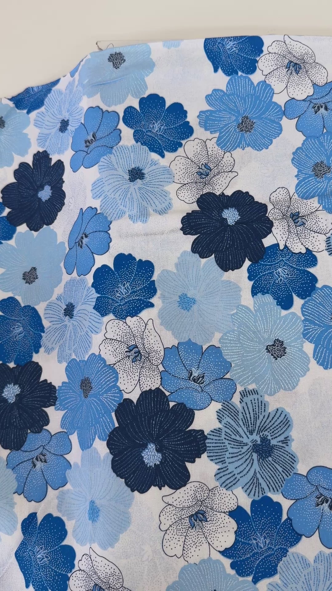 Blue and white flowers with pearlescent shimmer accents scattered across a white background, Packed Shimmer Flower White Pearlescent fabric by Greta Lynn for Kanvas Studio Benartex.