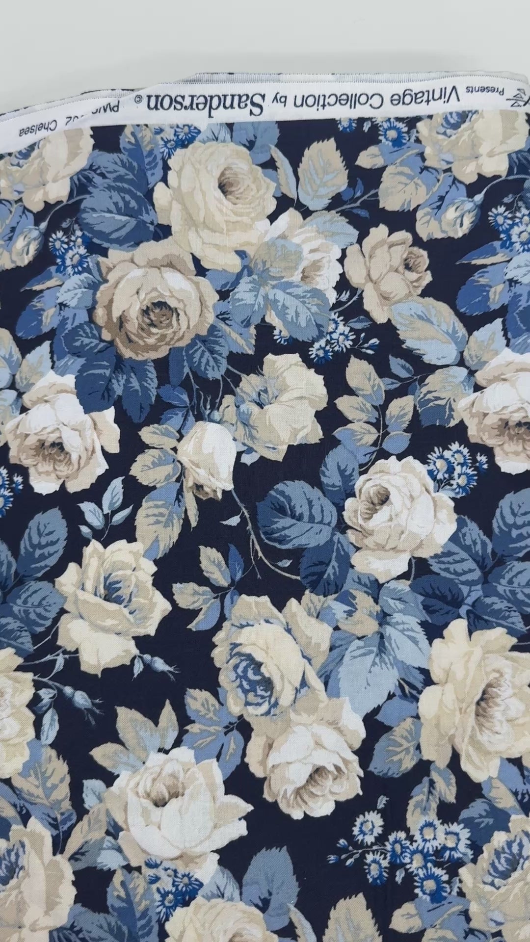 Elegant navy floral cotton fabric with cream roses and soft blue foliage from the Sanderson Vintage Collection by Free Spirit Fabrics.