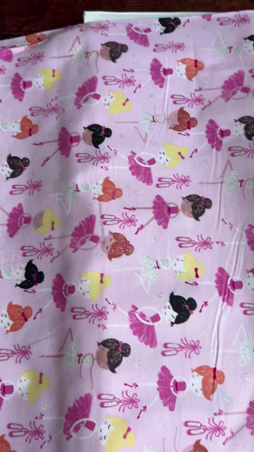 Pink cotton fabric featuring tossed ballerinas, tutus, ballet shoes, and silver glitter accents by Timeless Treasures.